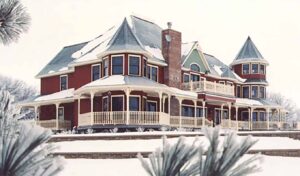Beautiful snow-covered victorian home with custom wood spindles from Island Post Cap.